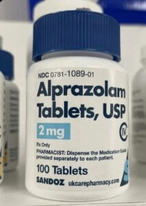 An official pharmaceutical bottle displaying a valid medical prescription label for alprazolam tablets, representing a secure avenue to find legitimate Xanax for sale.