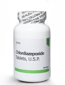 A professional medical photograph displaying a secure plastic prescription bottle with a sealed cap, providing a legitimate way to order Chlordiazepoxide online safely.